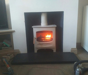 Charnwood Stove C5 wood burner in Almond - with a new section of internal factory made metal chimney system in Guildford, Surrey 
